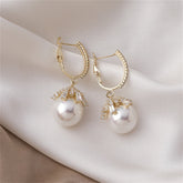 Stunning huggie earrings with white pearls and diamonds, set in luxurious 18K gold plating.